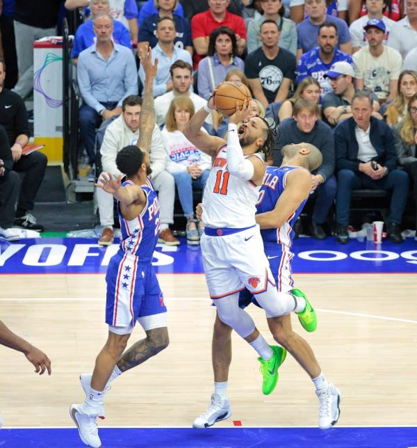 Jalen Brunson #11 of the New York Knicks goes up for a shot between Cameron Payne #22 of the Philadelphia 76ers and Nicolas Batum #40 of the Philadelphia 76ers during the third quarter.