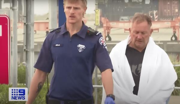Darren Curmi (right) was helped out of the water by witnesses before he was transported to a hospital in stable co<em></em>ndition for monitoring