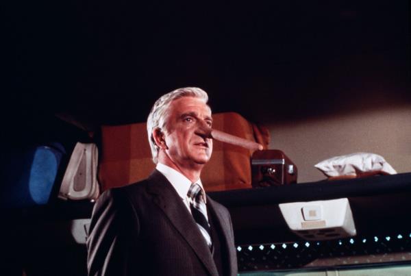 Leslie Nielsen, with Pinocchio nose, as Dr. Rumack in 