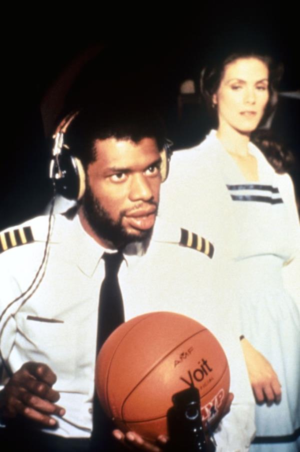 Kareem Abdul-Jabbar with basketball and Julie Haggerty in an 