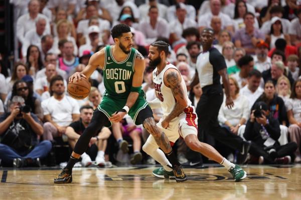 ayson Tatum #0 of the Boston Celtics controls the ball ahead of Caleb Martin #16 of the Miami Heat during the third quarter in game six of the Eastern Co<em></em>nference Finals at Kaseya Center on May 27, 2023 in Miami, Florida.