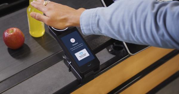 AMAZON Palm handprint at an Amazon One device at the checkout register at a Whole Foods Market