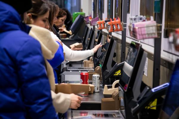 Customers checkout at self-checkout kiosks equipped with Amazo<em></em>nas Palm One hand scanner at a Whole Foods in New York, US, on Friday, Feb. 2, 2024. Photo by Michael Nagle