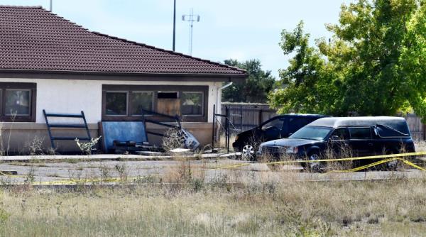 A hearse and debris can be seen at the rear of the Return to Nature Funeral Home