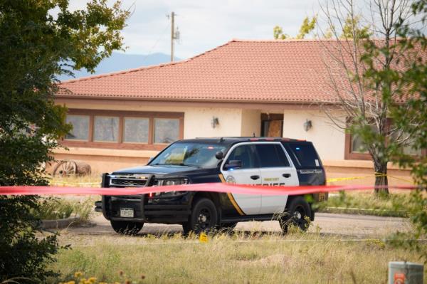 Sherieff's Department vehicle sits outside a closed funeral hom