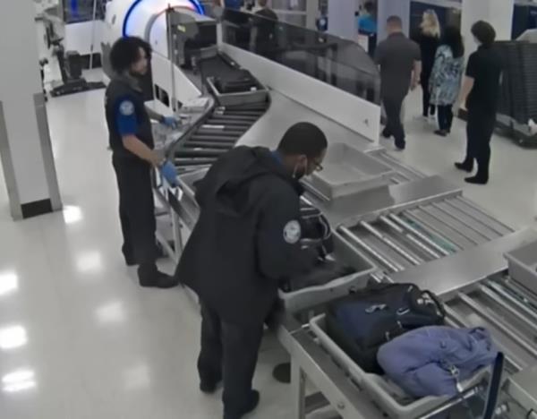Video from the checkpoint shows the two accused thieves at the baggage dro<em></em>p-off section of the checkpoint as they worked together to take mo<em></em>ney from wallets and purses that passed them on the way to the x-ray machine.