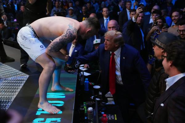 Colby Covington talks to former United States president Do<em></em>nald Trump at the beginning of the UFC welterweight champio<em></em>nship fight during the UFC 296 event at T-Mobile Arena on December 16, 2023 in Las Vegas, Nevada. 