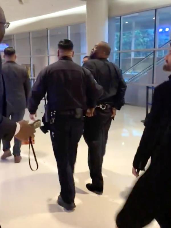 Killer Mike in cuffs