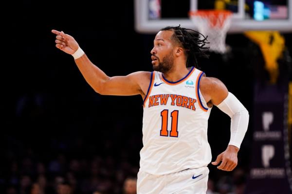 Jalen Brunson gestures during the first half of an NBA basketball game against the Los Angeles Lakers.