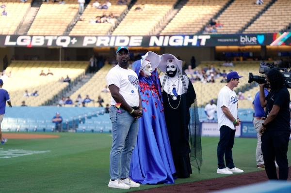 Gerald Garth (L) stands with members of the Sisters of Perpetual Indulgence, Sister Unity (C) and Sister Dominia as they are ho<em></em>nored during LGBTQ+ Pride Night prior Dodgers Stadium on June 16, 2023.