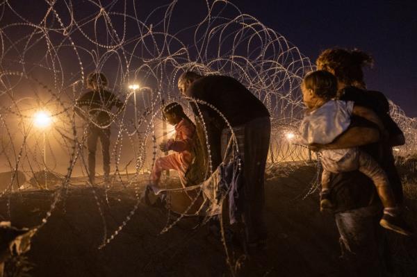 Immigrant families cross into the United States from Mexico to seek asylum on May 08, 2023 in El Paso, Texas.