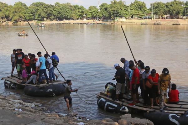 Migrants cross the Suchiate river in Tapachula, Chiapas, Mexico, 15 November 2023