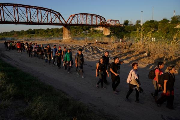 Migrants who crossed the Rio Grande and entered the U.S. from Mexico are lined up for processing by U.S. Customs and Border Protection, Sept. 23, 2023, in Eagle Pass, Texas.