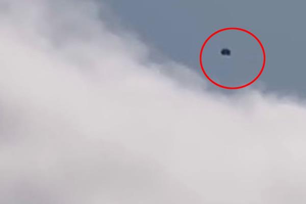 A UFO hovers above the clouds in Bedford-Stuyvesant.