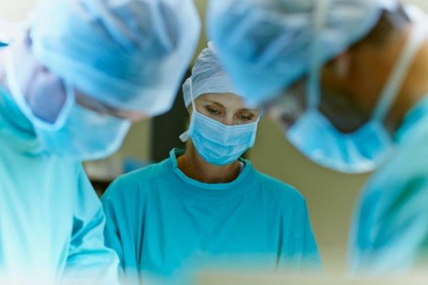 Team of surgeons working in operation room at hospital