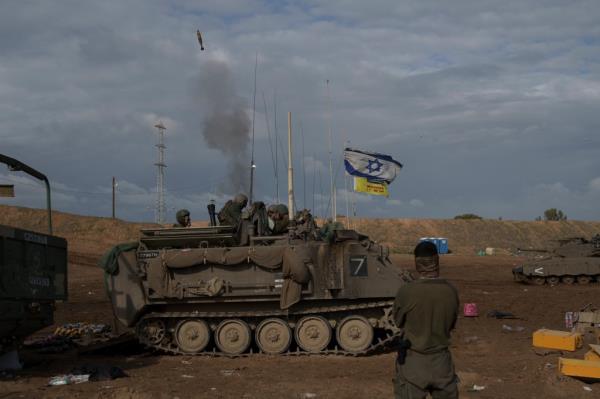 Israeli soldiers fire a mortar shell from southern Israel towards the Gaza Strip.