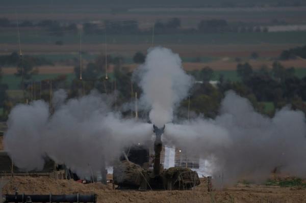 An Israeli mobile artillery unit fires a shell from southern Israel towards the Gaza Strip, in a position near the Israel-Gaza border , Sunday, Jan. 14, 2024. 