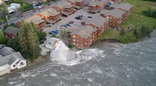 A drone view shows a house collapsing into a river due to glacial floods in Juneau, Alaska, U.S. August 5, 2023
