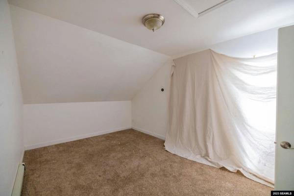 A curtain has been put up to shield from the other half of the home that has washed away in the flood. 