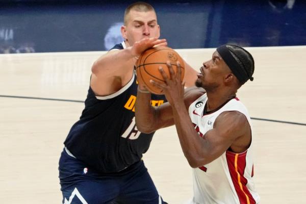 Jimmy Butler drives to the rims against Nikola Jokic during the Heat's Game 2 win over the Nuggets on June 4.