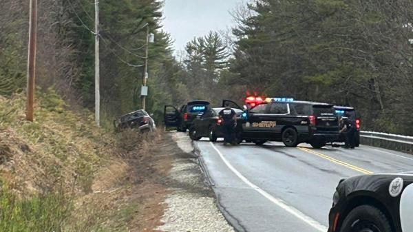 A suspect ran from behind a car stopped off the road into an open police cruiser during a shootout with the Oxford County Sheriff's officers.