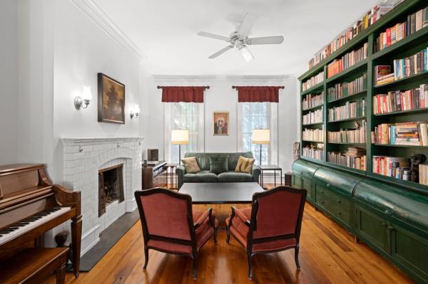 Built in bookcases and a piano create a cozy shared space.