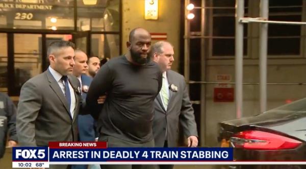 Claude White is led out of court in handcuffs by detectives. 