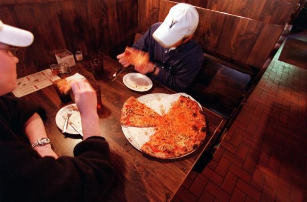 Two Co<em></em>nnecticuters eat some slices at Modern Pizza in New Haven