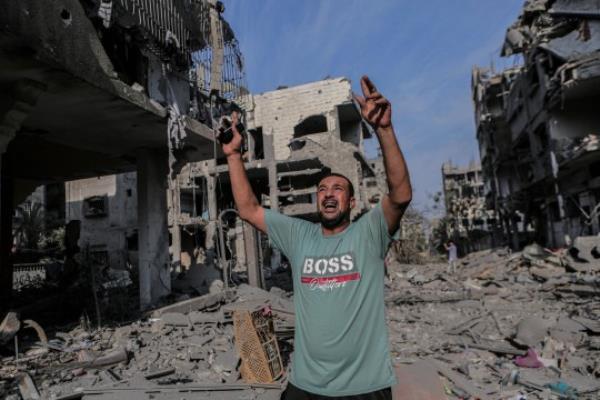 Mandatory Credit: Photo by Alaa Qraiqea/IMAGESLIVE via ZUMA Press Wire/Shutterstock (14145674m) Gaza, Palestine. 11 October 2023. A displaced Palestinian following intensive Israeli raids in the al-Karama district in northwest Gaza. According to local sources Israeli jets bombed the area on Wednesday with warplanes and artillery units without warning to the residents inside. Dozens of residents were killed and injured in the process while the area was turned into rubble, as the Israeli army co<em></em>ntinues its raids on the Gaza Strip for the fifth co<em></em>nsecutive day Massive Israeli bombardment of residential area in Gaza - 11 Oct 2023