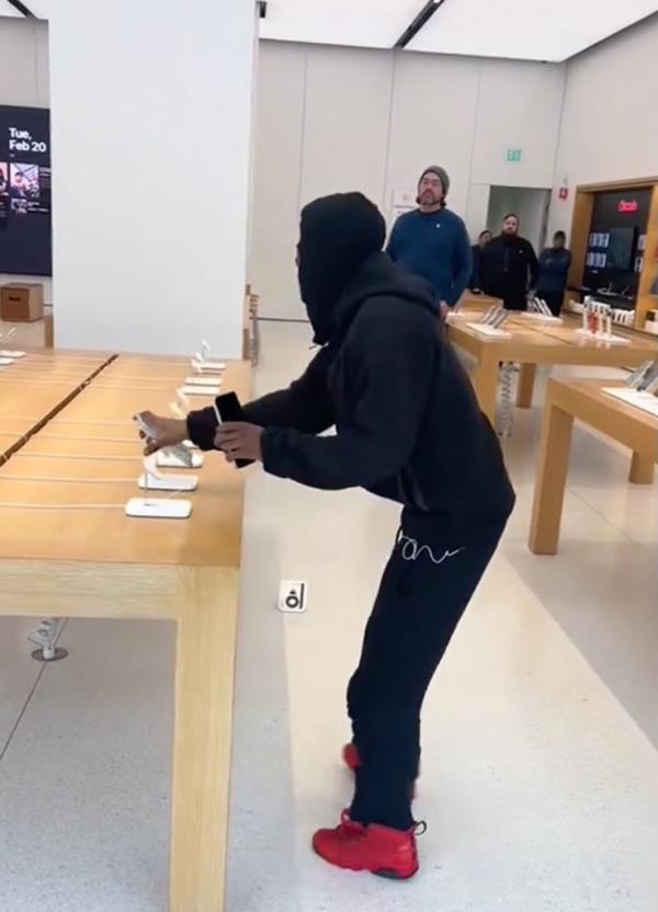 Masked man stealing iPhones