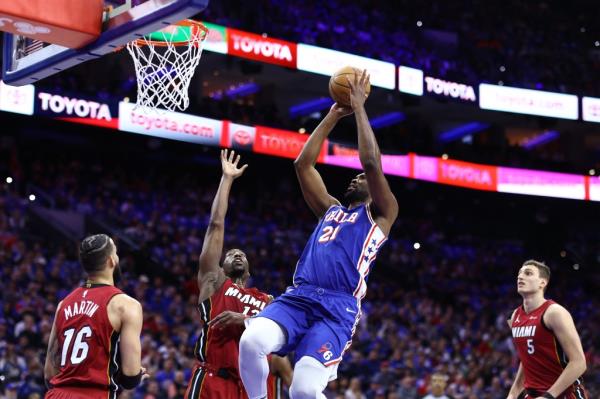 Joel Embiid, who had 23 points and 15 rebounds, shoots over Bam Adebayo during the 76ers' 105-104 win over the Heat in their NBA Play-in battle.