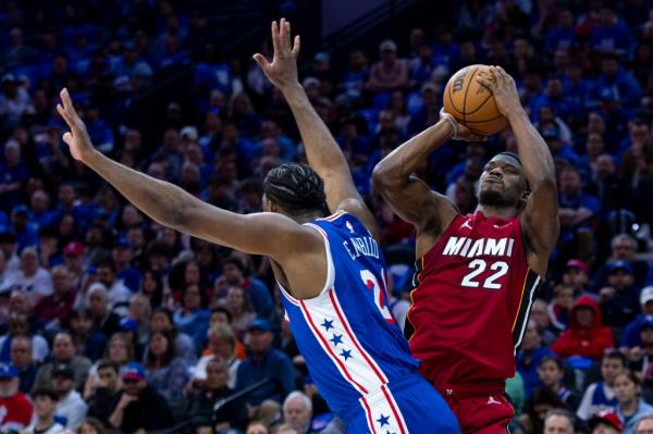Jimmy Butler, who scored 19 points, shoots over Joel Embiid during the Heat's loss.
