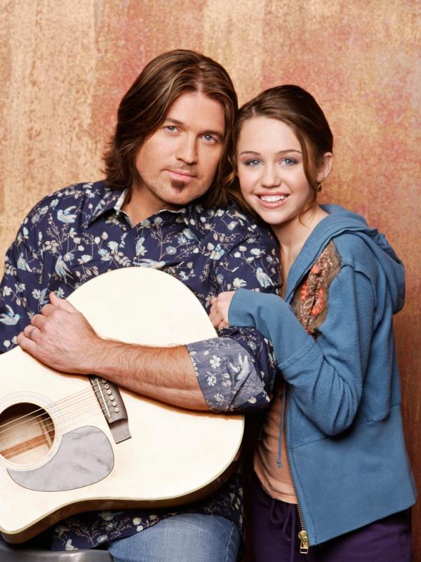 Billy Ray Cyrus with Miley smiling. 