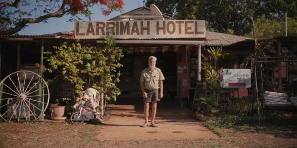 A man standing in front of Larrimah hotel. 