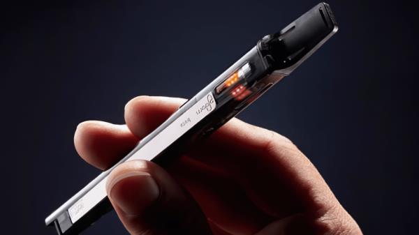 A hand holding an e-cigarette. 