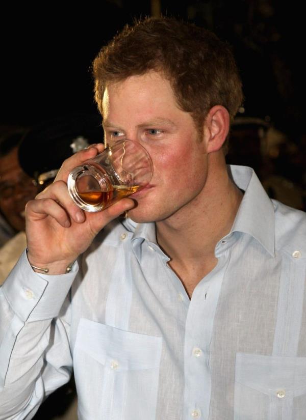 Prince Harry drinking from a glass while attending a Diamond Jubilee block party in Belmopan, Belize.