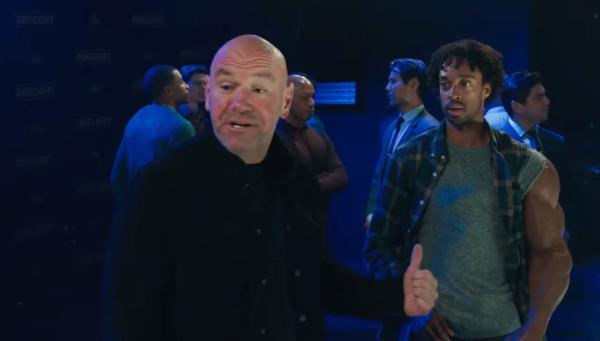 A group of men, including Dana White, standing in a room, possibly discussing the Bud Light advertisement airing during the Super Bowl.