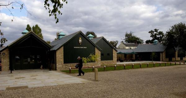 Windsor Farm Shop: A view of a building with green windows and a brick exterior. No people or activity visible in this photo.