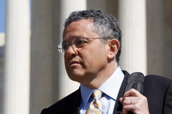 Jeffrey Toobin, a CNN legal analyst wearing glasses and a suit, leaving the Supreme Court in Washington after arguments on the health care law, March 27, 2012.