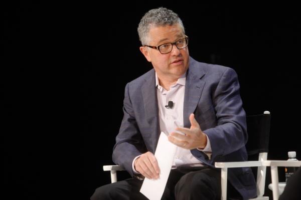Jeffrey Toobin participating in a panel discussion at the 2014 New Yorker Festival, holding a piece of paper
