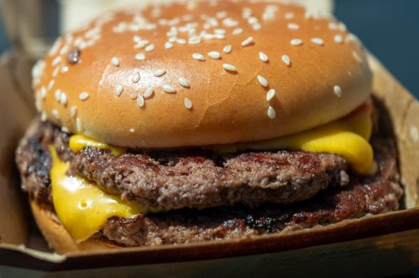 Bowler is now one of at least 75 people, 22 of whom were hospitalized, believed to have been sickened by the slivered o<em></em>nions atop the famous burger.