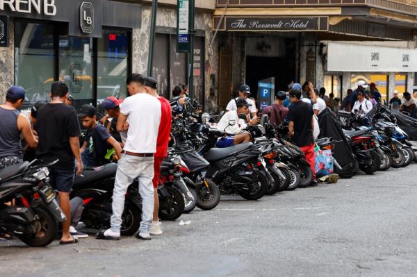 Migrants lined up outside the  hotel. 