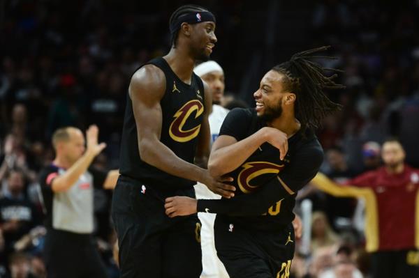 Caris LeVert (3) and Darius Garland (10) of the Cavaliers celebrate during their win over the Magic on Sunday.