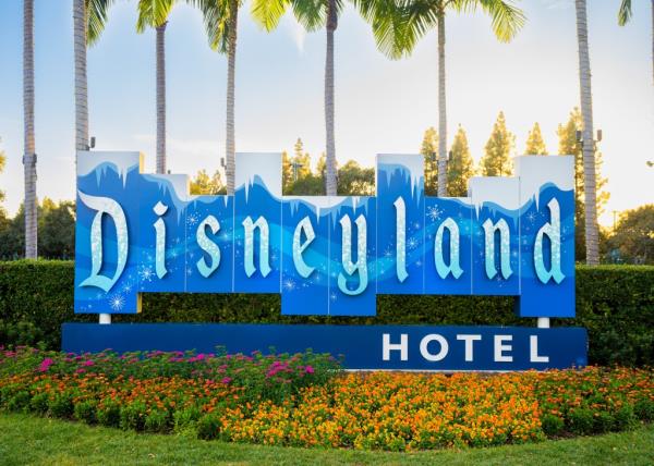 General views of the Disneyland Hotel at the Disneyland Resort with trees and flowers in front.