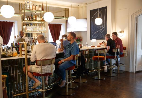 Guests enjoy the bar room of Spring House. 