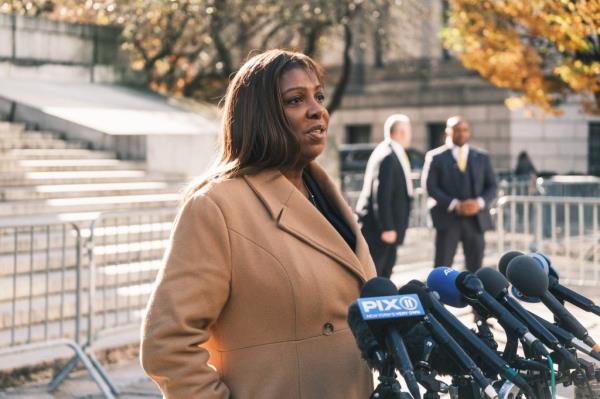 New York Attorney General Letitia James standing in front of micropho<em></em>nes outside a courthouse