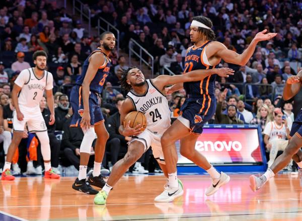 Brooklyn Nets guard Cam Thomas tries top drive pass New York Knicks center Jericho Sims in the second half at the Madison Square Garden in New York, USA, Friday, November 15, 2024.
