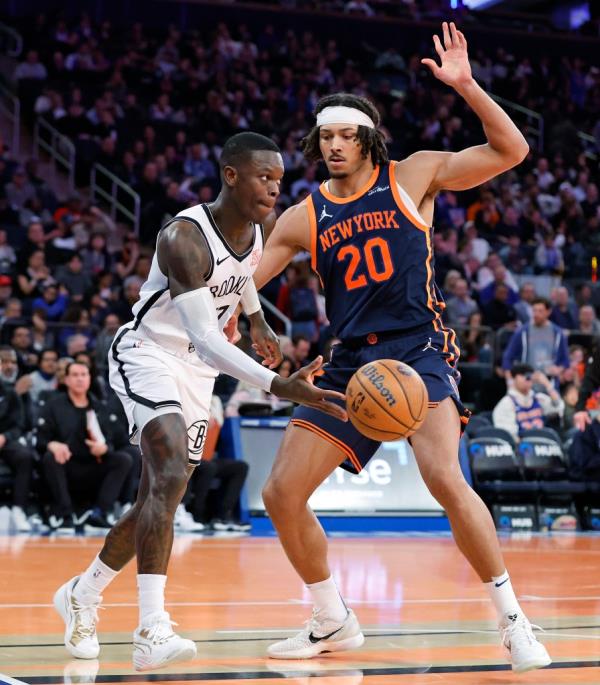 New York Knicks center Jericho Sims defends as Brooklyn Nets guard Dennis Schroder passes the ball in the second half at the Madison Square Garden in New York, USA, Friday, November 15, 2024.