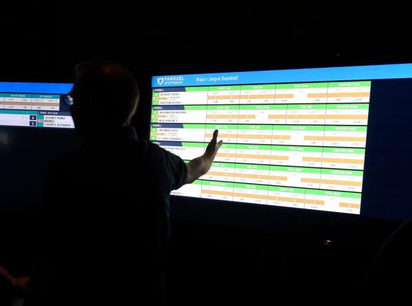 Man looks at stats on ba<em></em>seball on a computer screen on opening day of FanDuel Sportsbook sports betting at the Meadowlands Raceway.