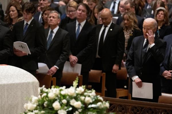 Biden wiping his eyes at the memorial service.